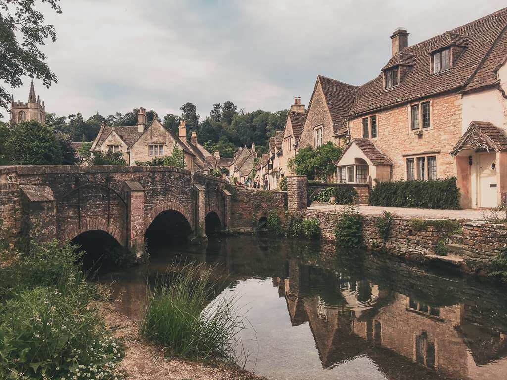 beautiful homes and bridge over creek in castle combe