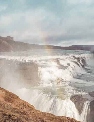 beautiful gullfoss waterfall in iceland on golden circle with rainbow in background- cost of a trip to iceland