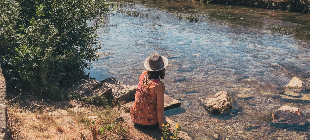 Girl sitting along river - Blog