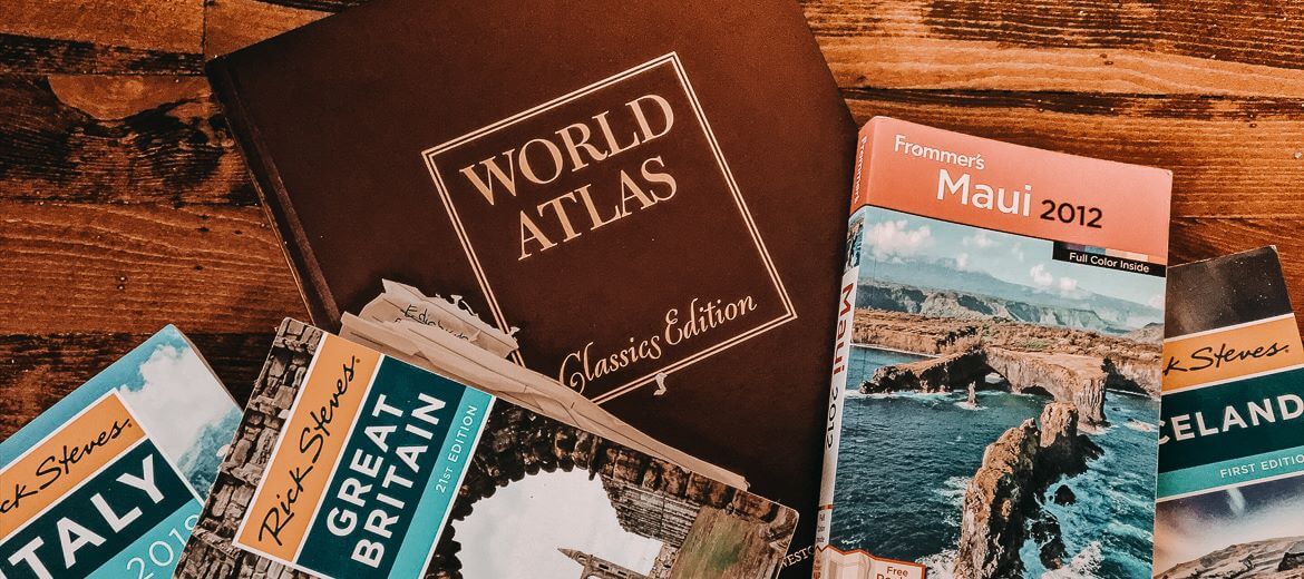 Travel books on wooden floor - Foreign Language Obsession: Learning 2 At Once