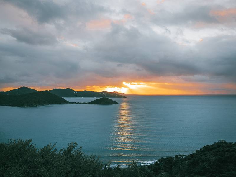 orange and pink sunrise over the blue waters of Coral Bay