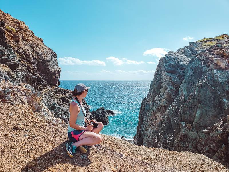 Girl viewing turquoise waters while hiking the Ram Head Trail on St John