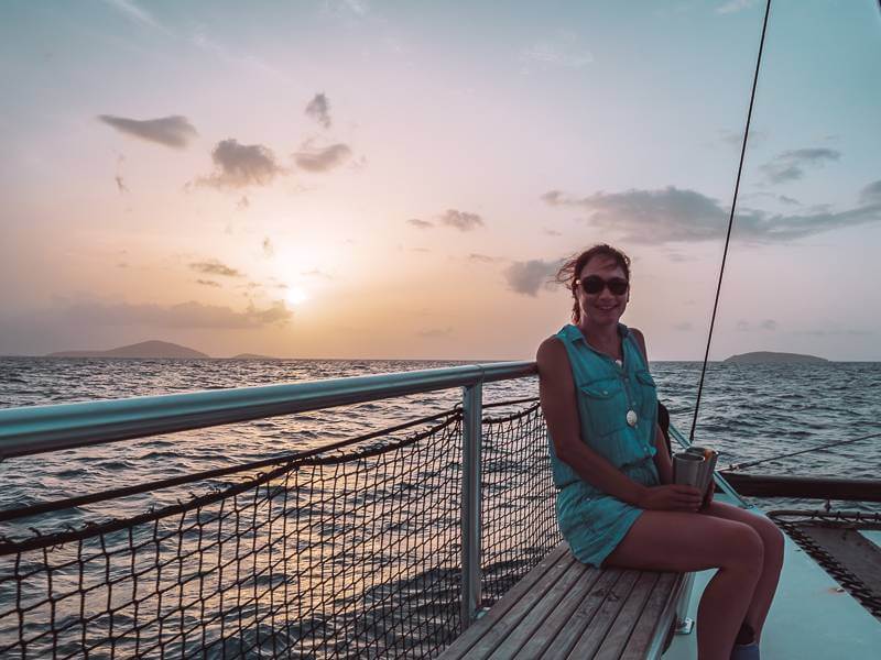 Girl sitting on Kekoa while on sunset sail - things to do in st john usvi