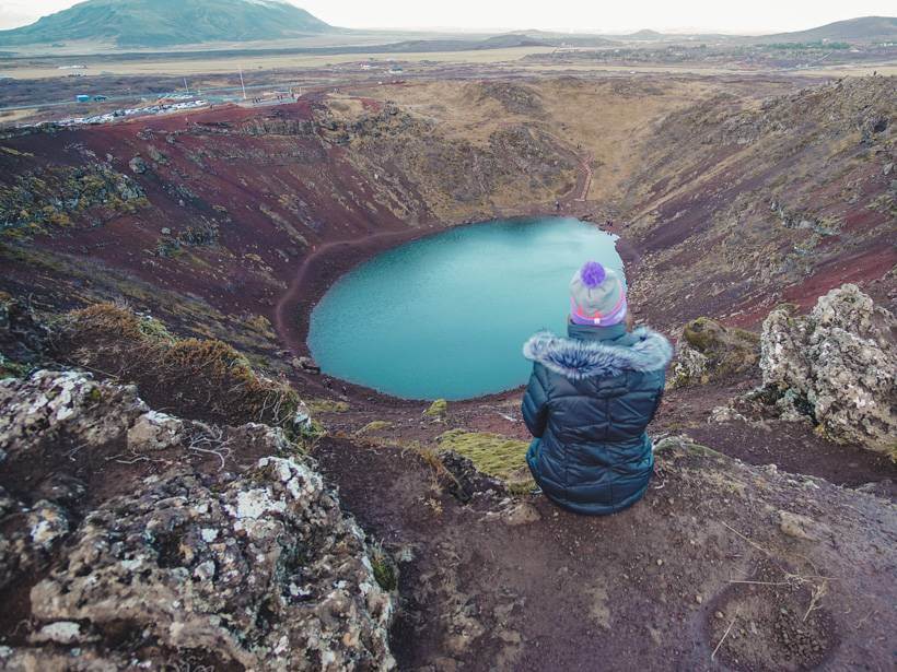 Girl sitting on edge of Kerid crater during Golden Circle day trip - 4 days in Iceland