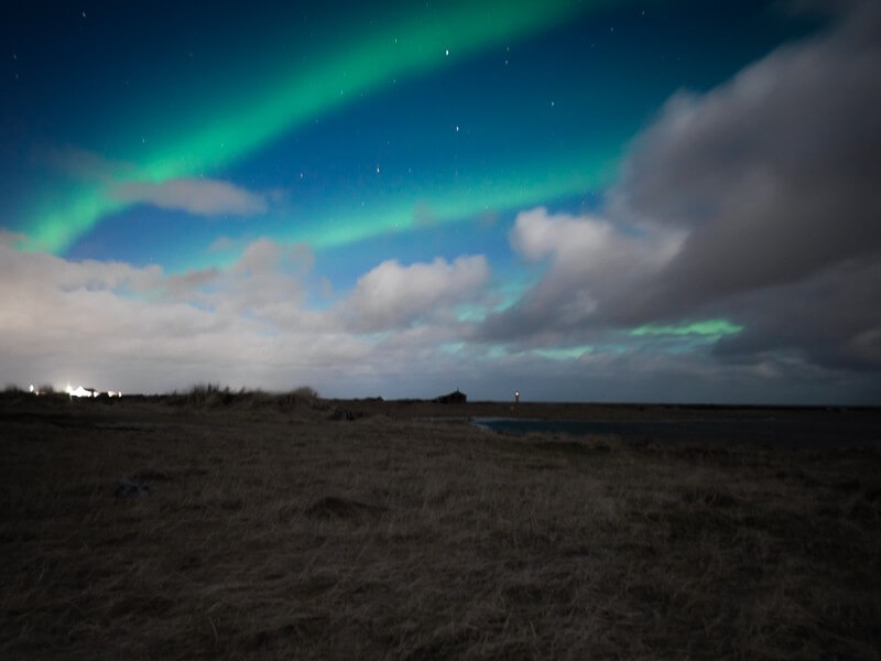 Green bands of the northern lights stretching across the sky - 4 days in Iceland