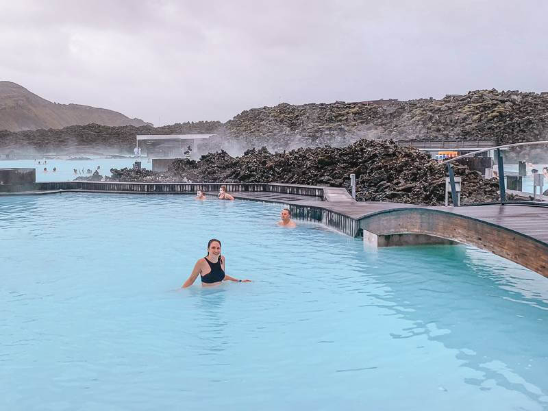 Girl in black swimsuit soaking in milky blue waters of Blue Lagoon - 4 days in Iceland