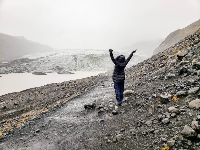Girl standing before the Sólheimajökull Glacier