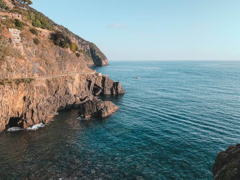 view of the teal sea against the rocky coastline in Riomaggiore during 2 days in Cinque Terre