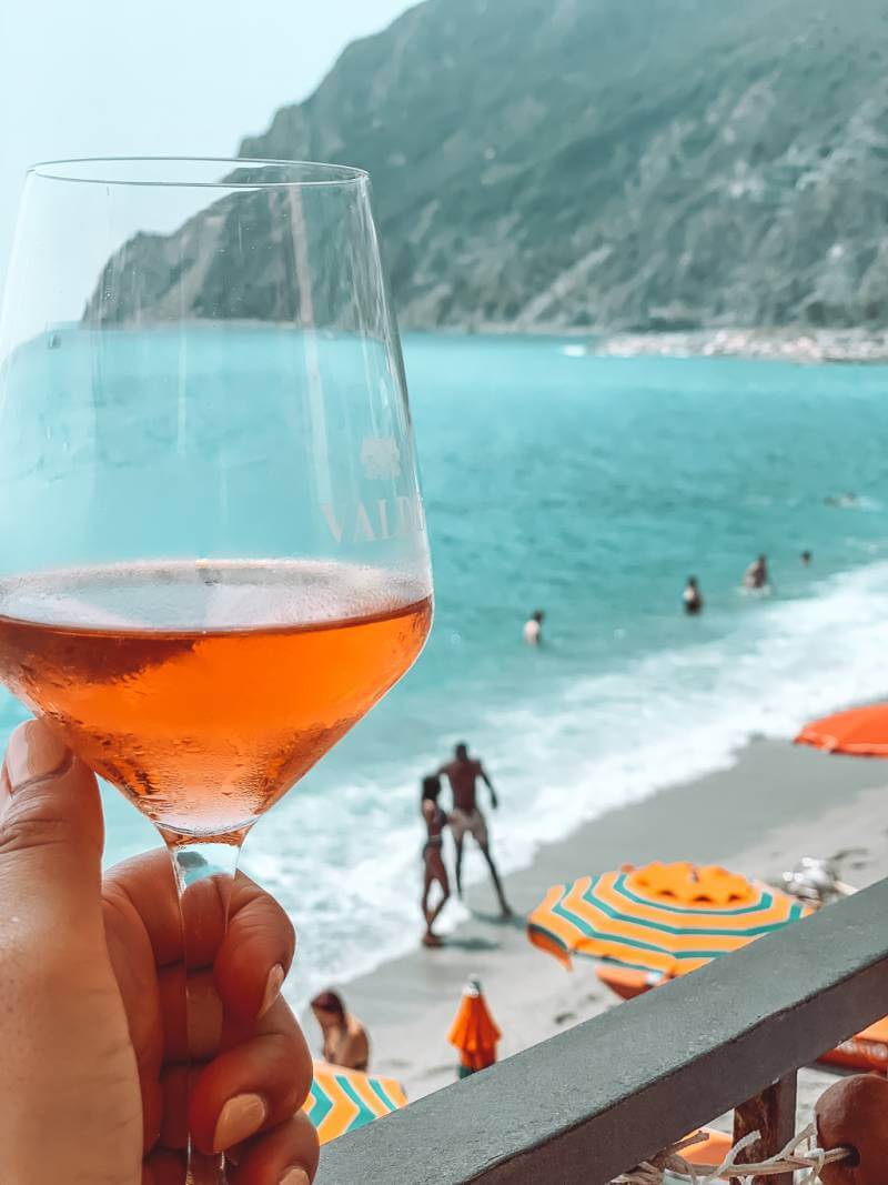 glass of rose with ligurian sea in the background in monterosso