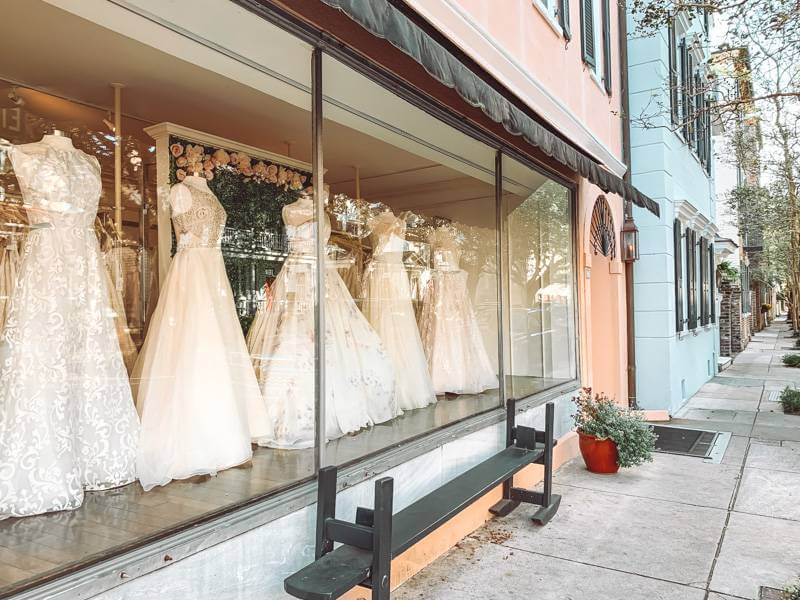 Wedding dresses lining an entire boutique window display in Charleston, SC