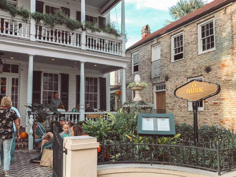 exterior of Husk restaurant in white house with double decker porch - romantic things to do in Charleston SC