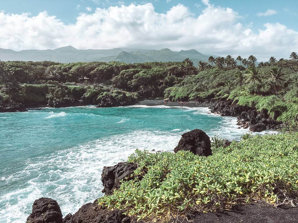 far away view of black sand beach on road to hana in maui