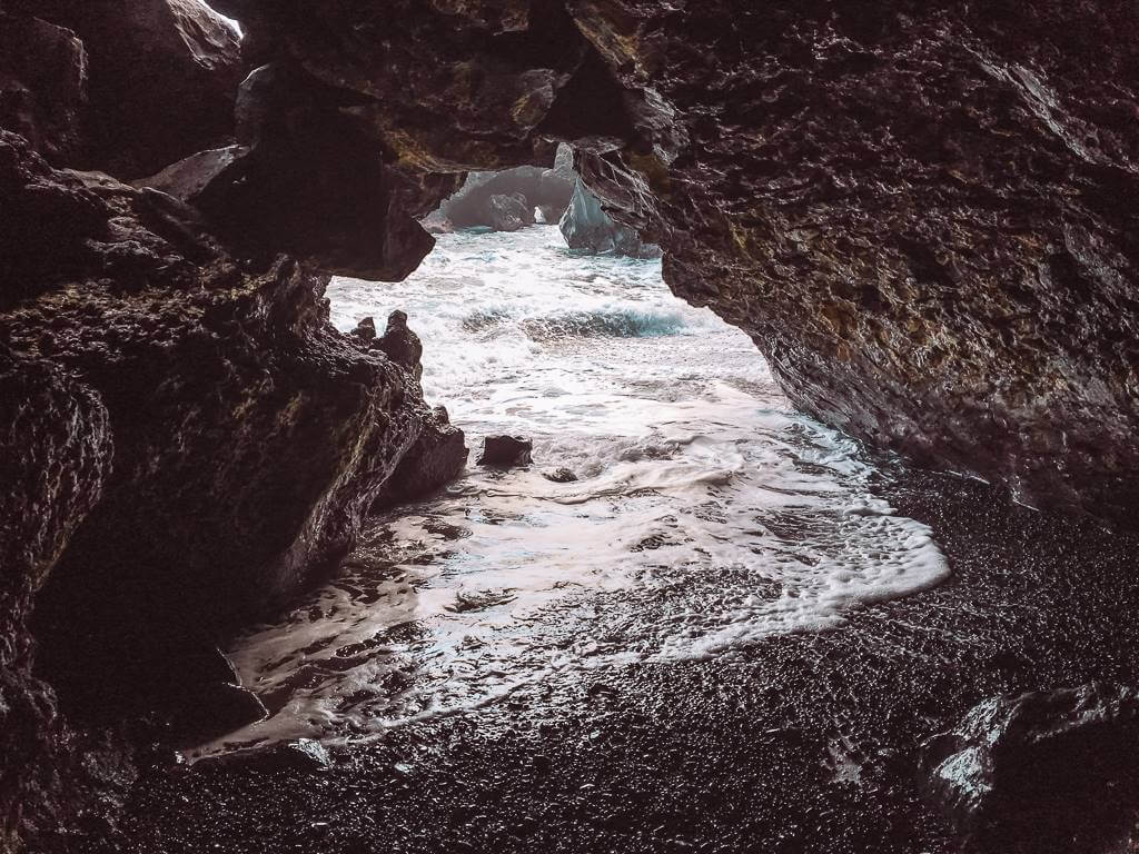 black rock cave near black sand beach on road to hana in maui