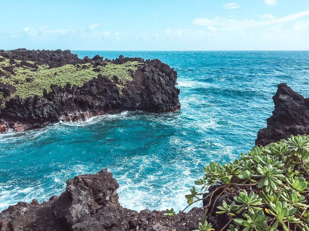 beautiful sapphire colored water at black sand beach hike in maui