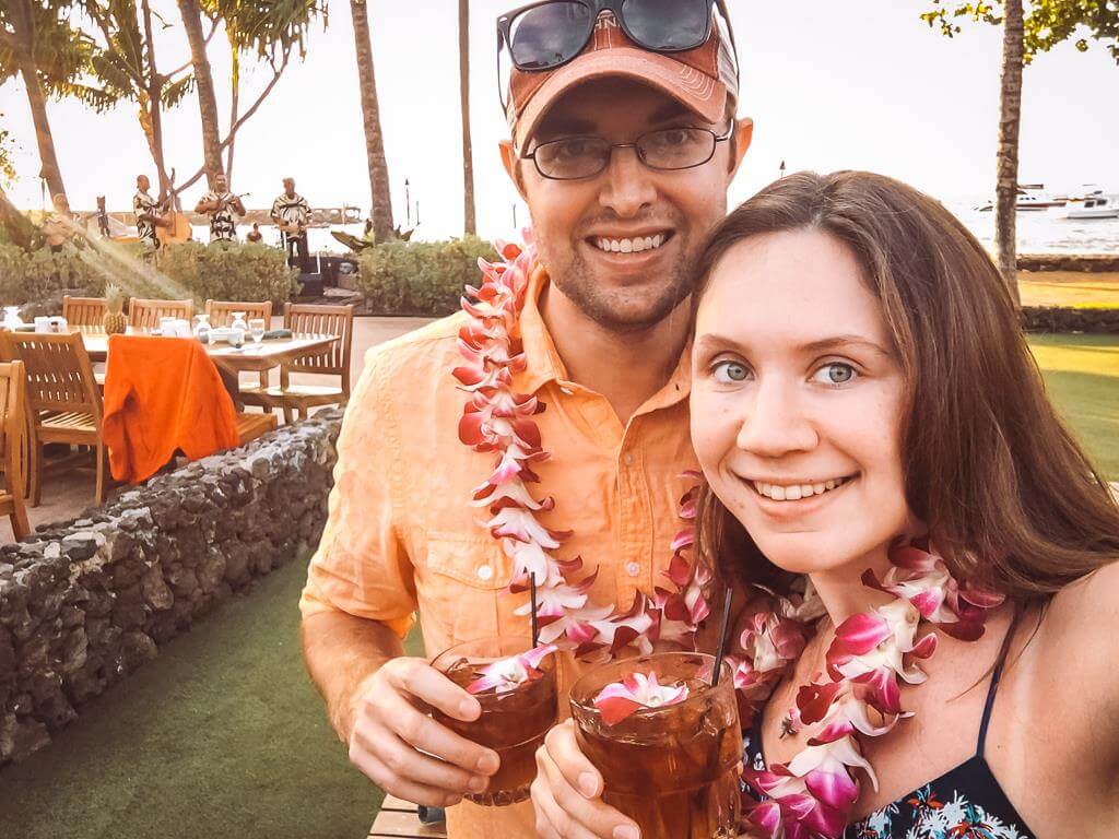 couple wearing Hawaiian leis at a luau