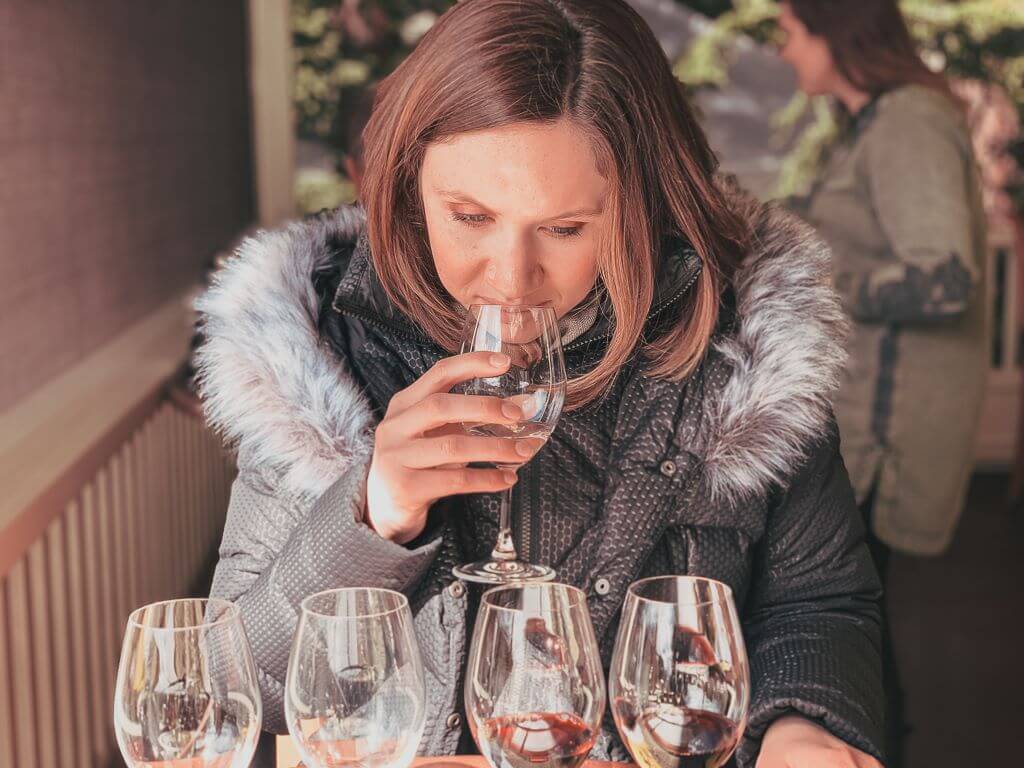 girl sipping a wine flight at Duckhorn winery