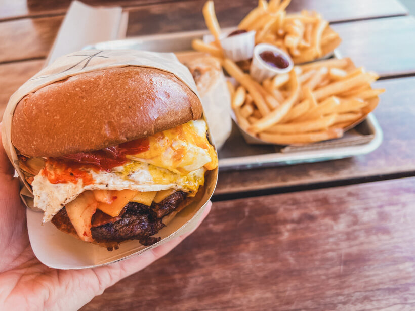 Kimchi burger from Grott's Roadside stand on wooden table