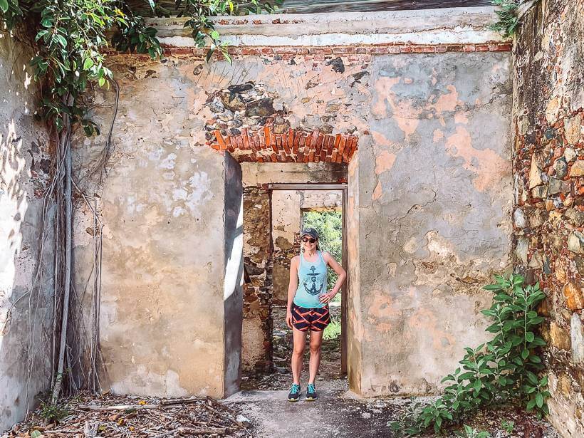 girl standing in doorway of colonial ruins on reef bay trail in st john usvi