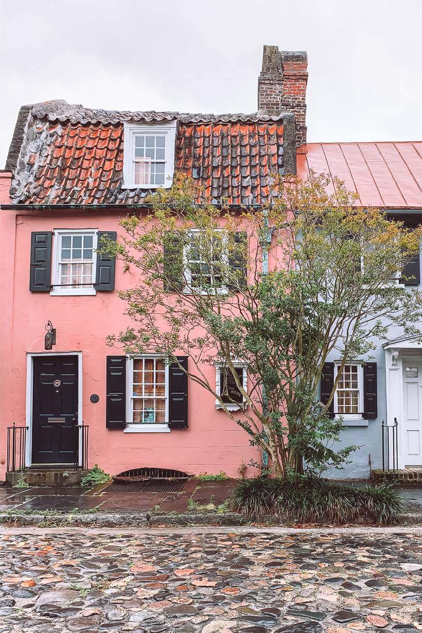 pink house with tile roof scene on cobblestone street - 3 days in charleston