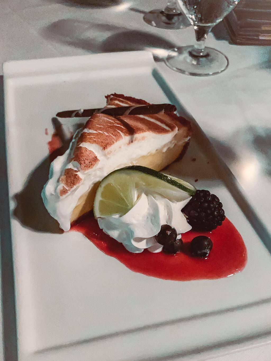 key lime pie from latitudes dressed up with chocolate straw and berry sauce