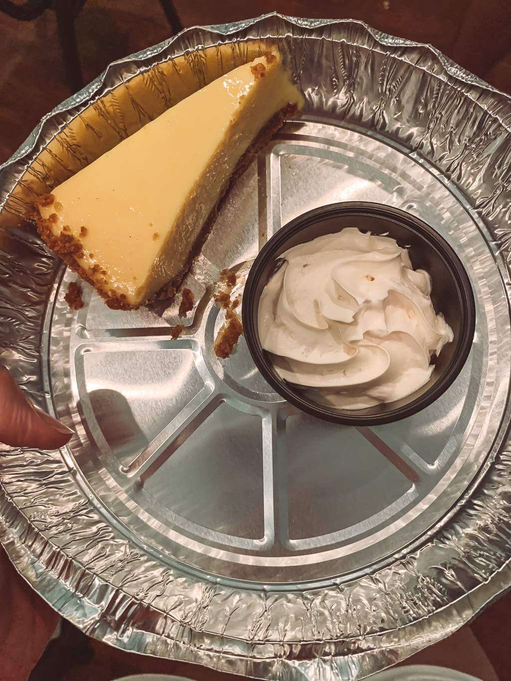 slice of key lime pie in a foil takeout container from La Te Da