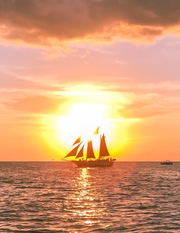 View of sunset behind sailboat near key west - fun things to do in key west