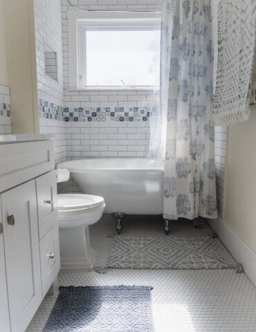 View of Greece inspired bathroom with linen walls and blue and white decor