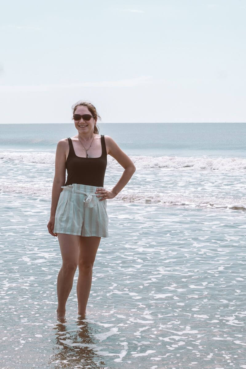 girl standing in gentle waves at Isle of Palms
