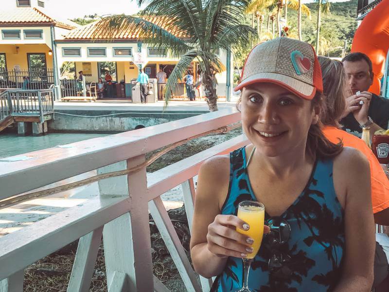 girl enjoying a drink at high tide - best restaurants in st john usvi