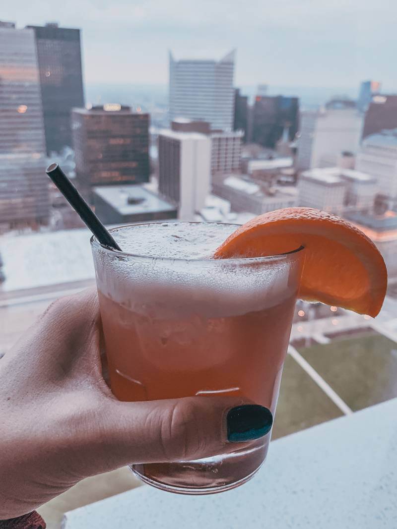 Festivus bourbon cocktail with downtown Cleveland in the background at Bar 32