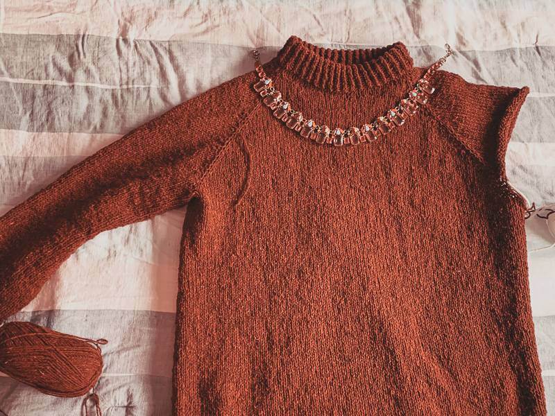 red sweater in the process of being knit