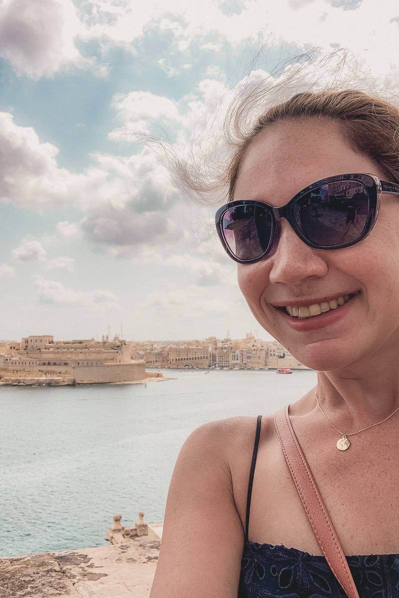 Girl standing in from of Grand Harbour in Valletta, Malta