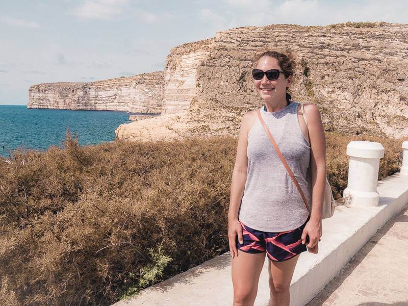 Girl standing in front of cliffs on Gozo in Malta