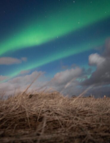 bands of the northern lights in Iceland stretching across the night sky