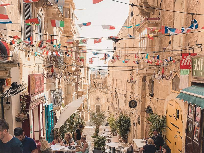 stone steps lined with restaurants in Valletta - malta trip cost