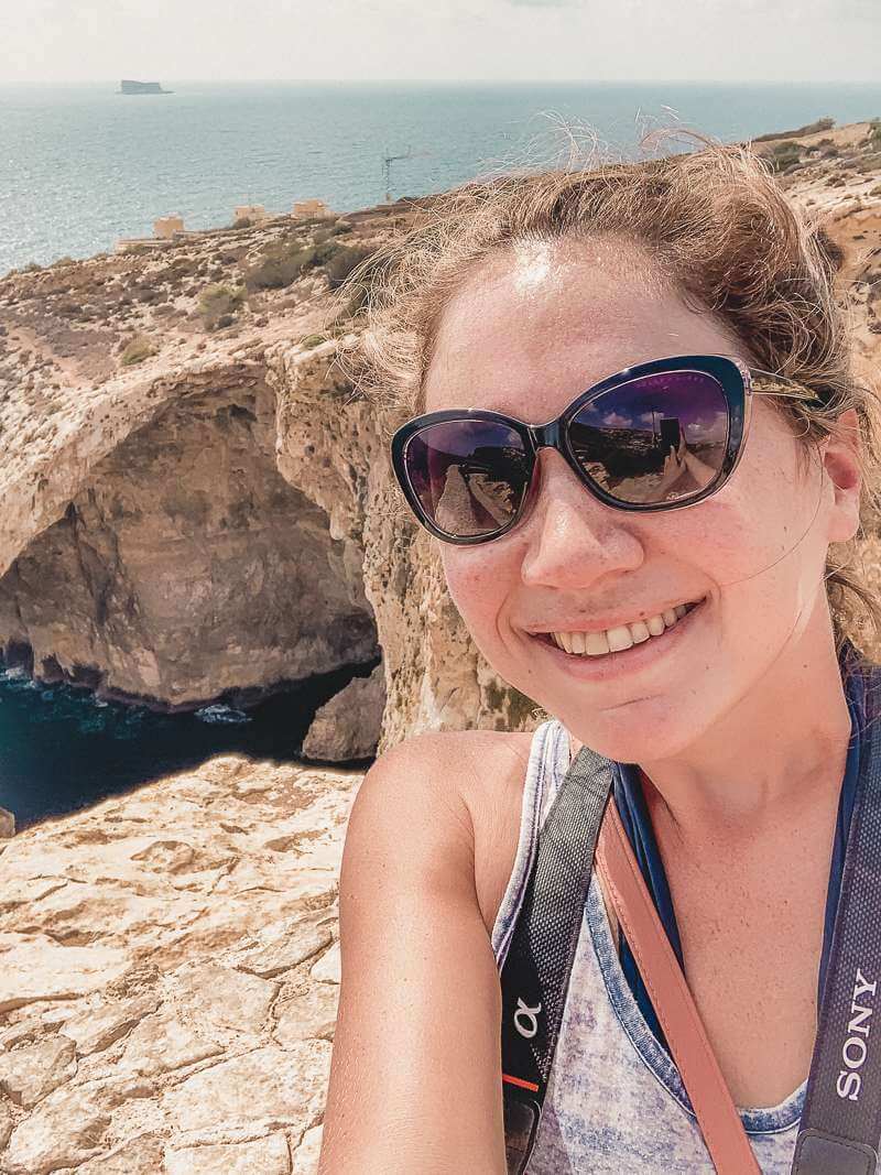 Girl standing at Blue Grotto viewing point - solo travel Malta