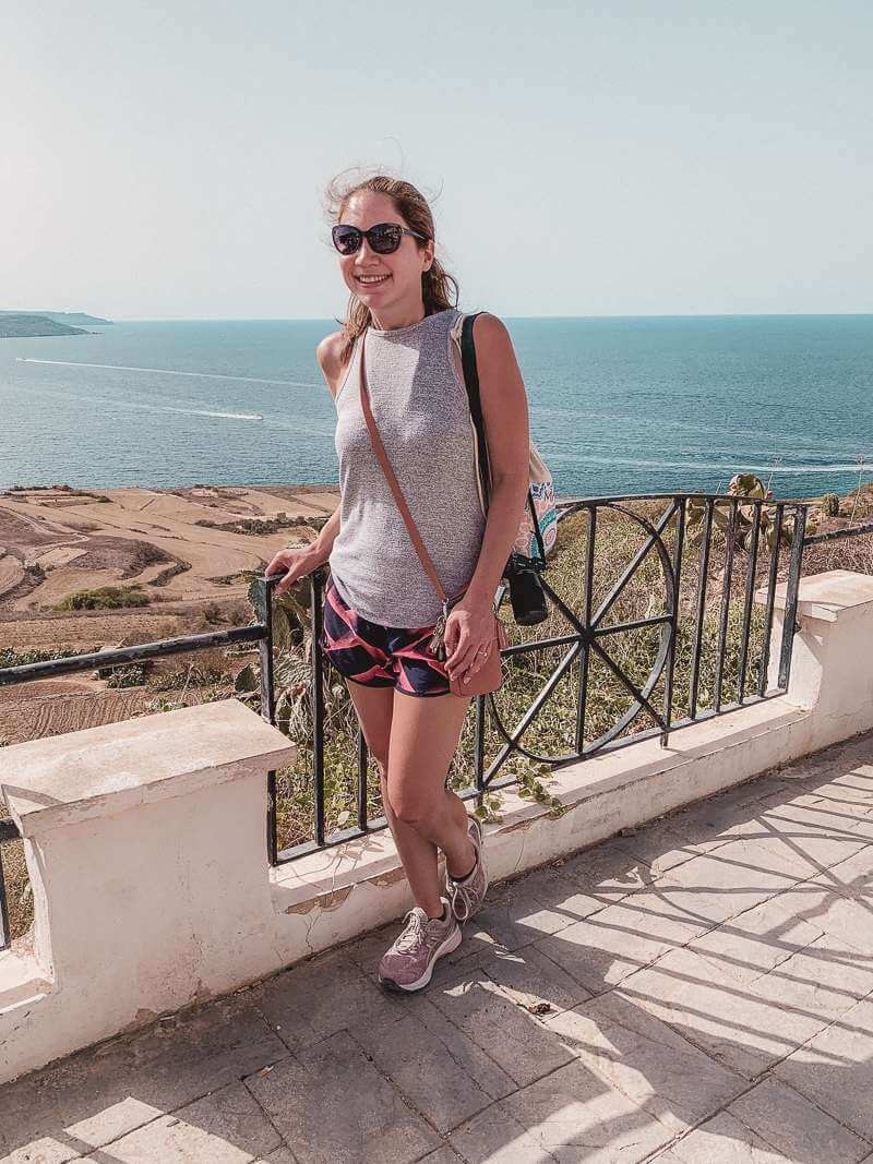 Girl standing by overlook in Gozo with Mediterranean in the background