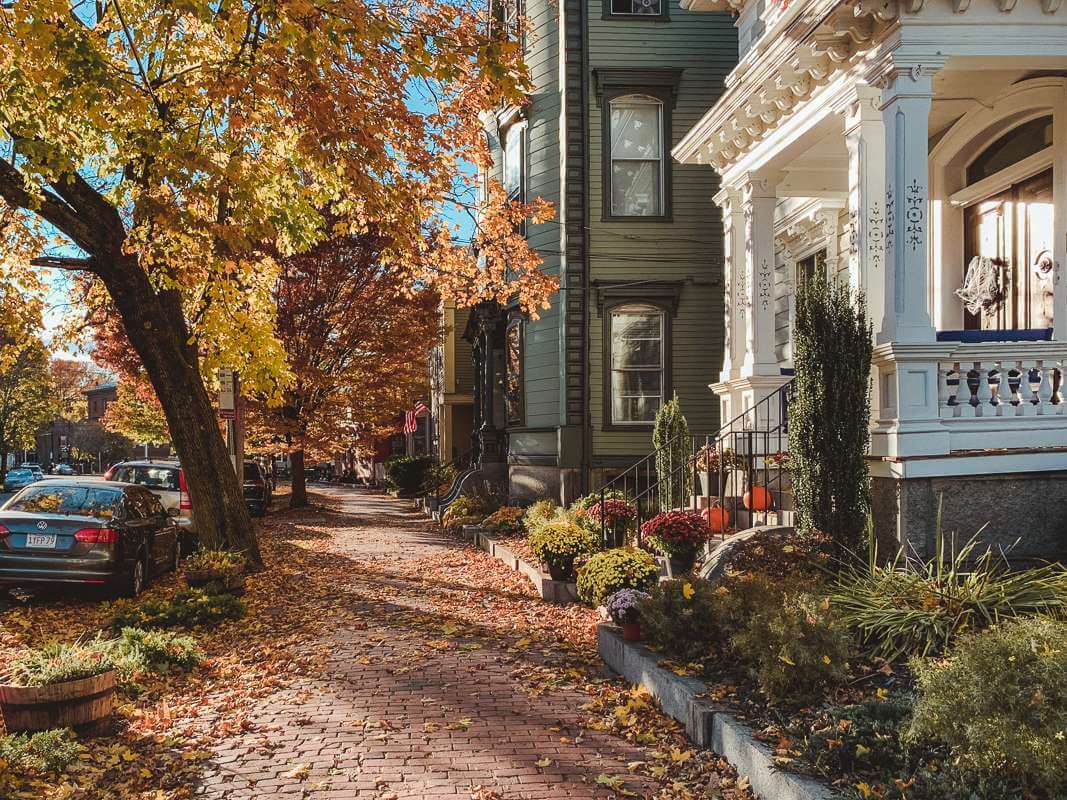 Brick sidewalk past old homes dressed up for fall - trip to Salem MA