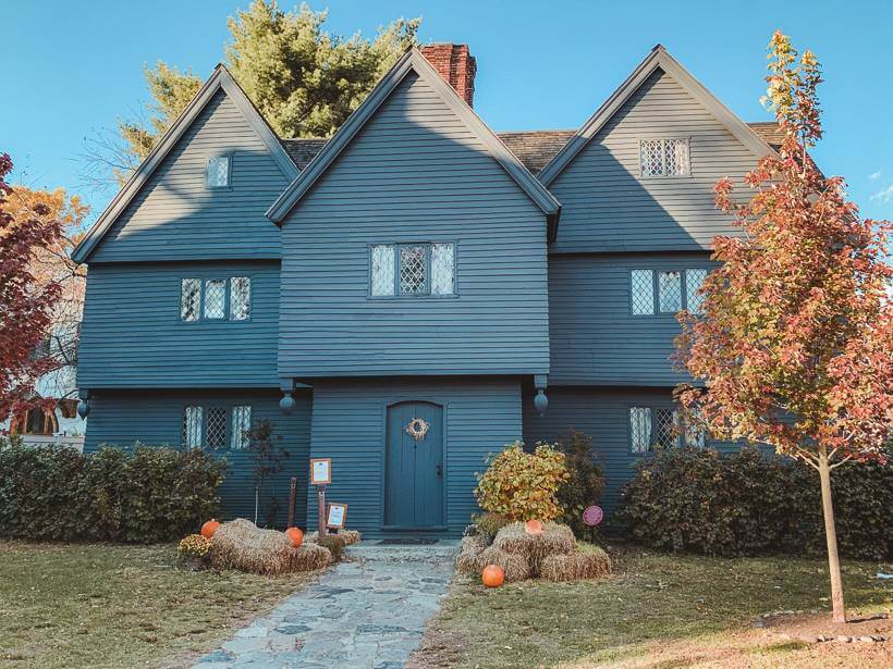 Exterior front lawn and dull blue facade of Witch House