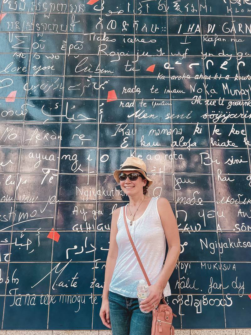 Girl standing in front of Love Wall in Montmartre - Packing for Paris
