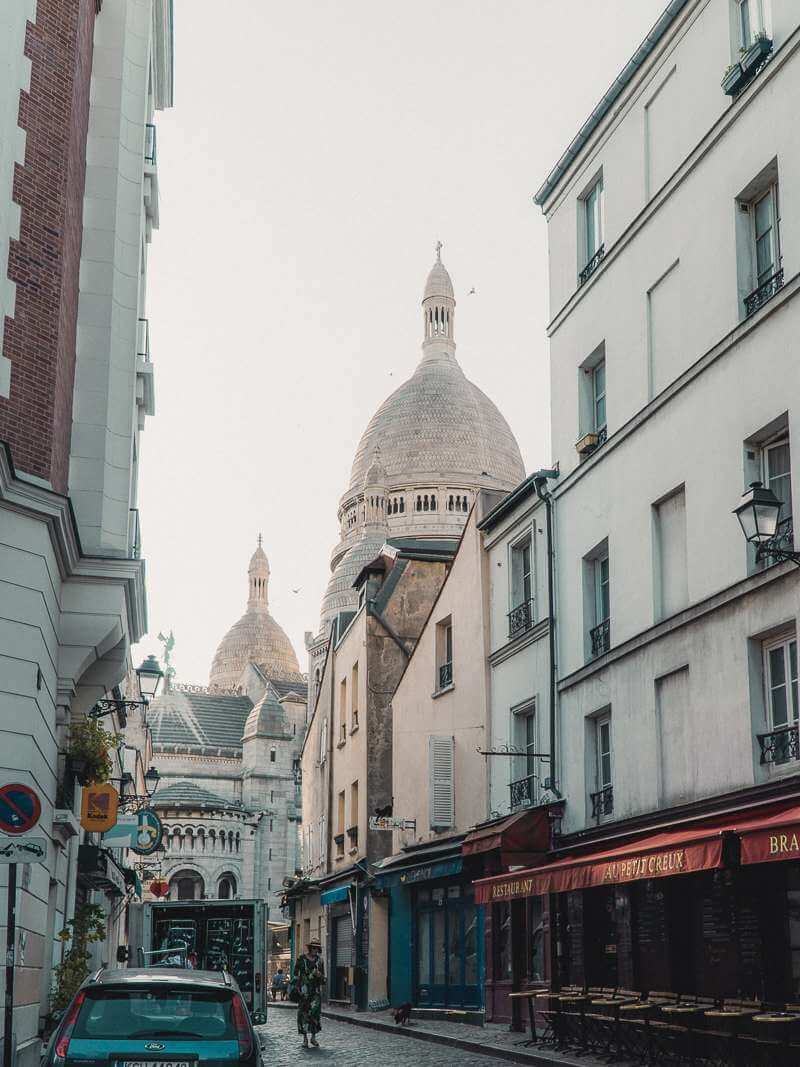 Beautiful view of Sacre Coeur tower down Rue du Chavelier de la Barre