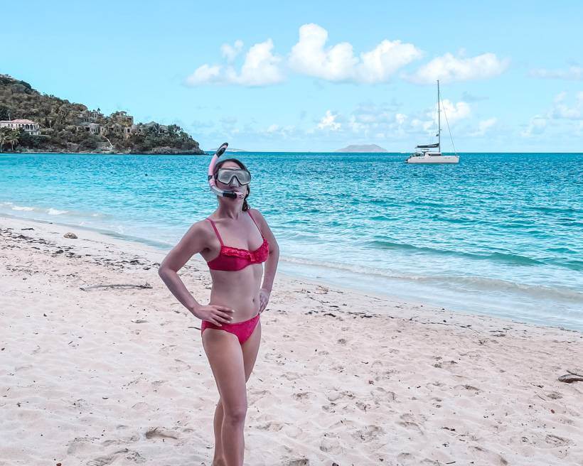 Girl in pink bikini wearing snorkel and mask at Little Cinnamon Beach on St John USVI