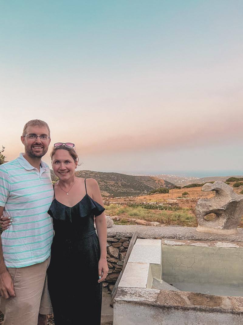 Man and woman posing together at winery on Paros with view out to the sea