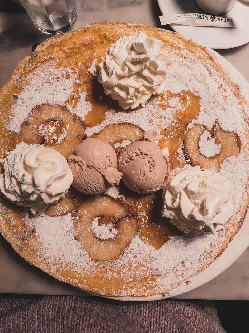Dutch pancake with apples, ice cream, and whipped cream at Dutch Pancake Bakery in Amsterdam