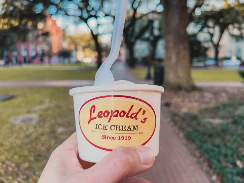 Holding a cup of Leopold's Ice Cream while crossing a square in Savannah, GA