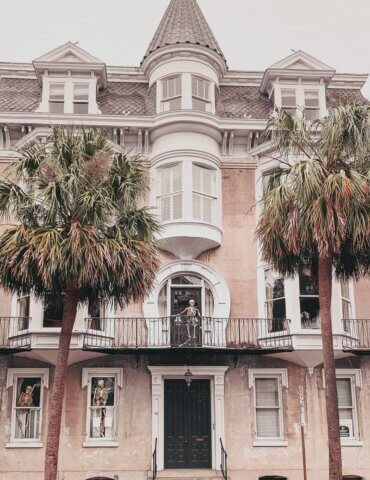 Mansion with pointy roof and skeleton decorations on gray overcast day during fall in Charleston SC