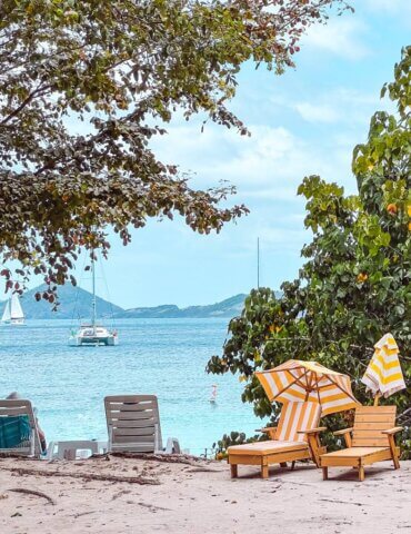 Orange striped chairs and umbrellas along Honeymoon Beach on St John in the US Virgin Islands