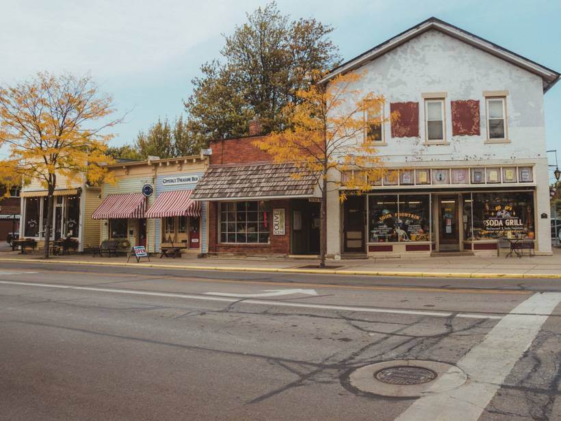 Exterior facades of old timey soda shop and other boutiques in downtown Vermilion, Ohio