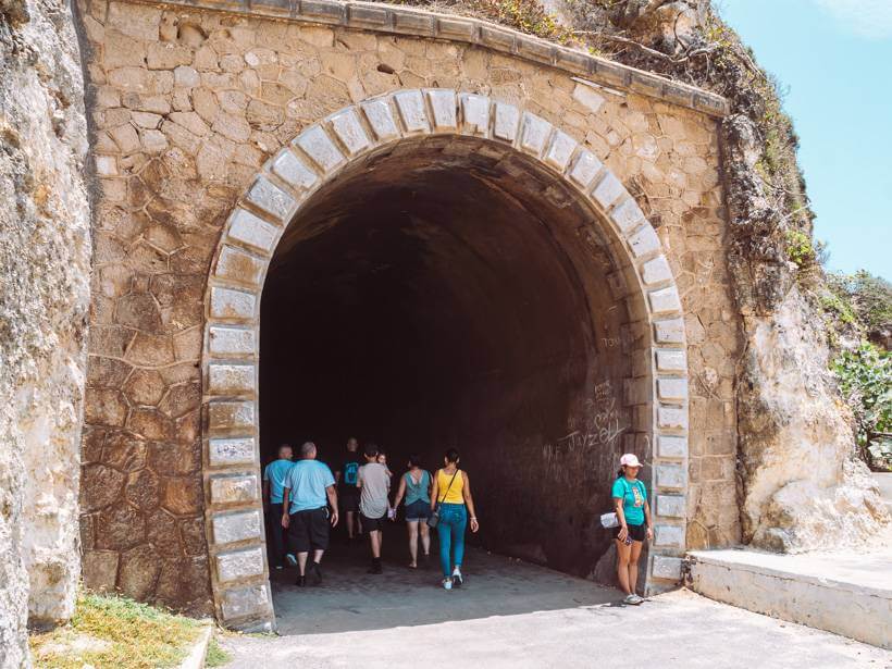 Group of young people entering the Guajataca historic railroad tunnel