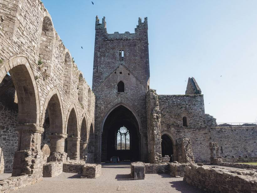 Tower and gothic arch ruins of the former Jerpoint Abbey monastery in Ireland